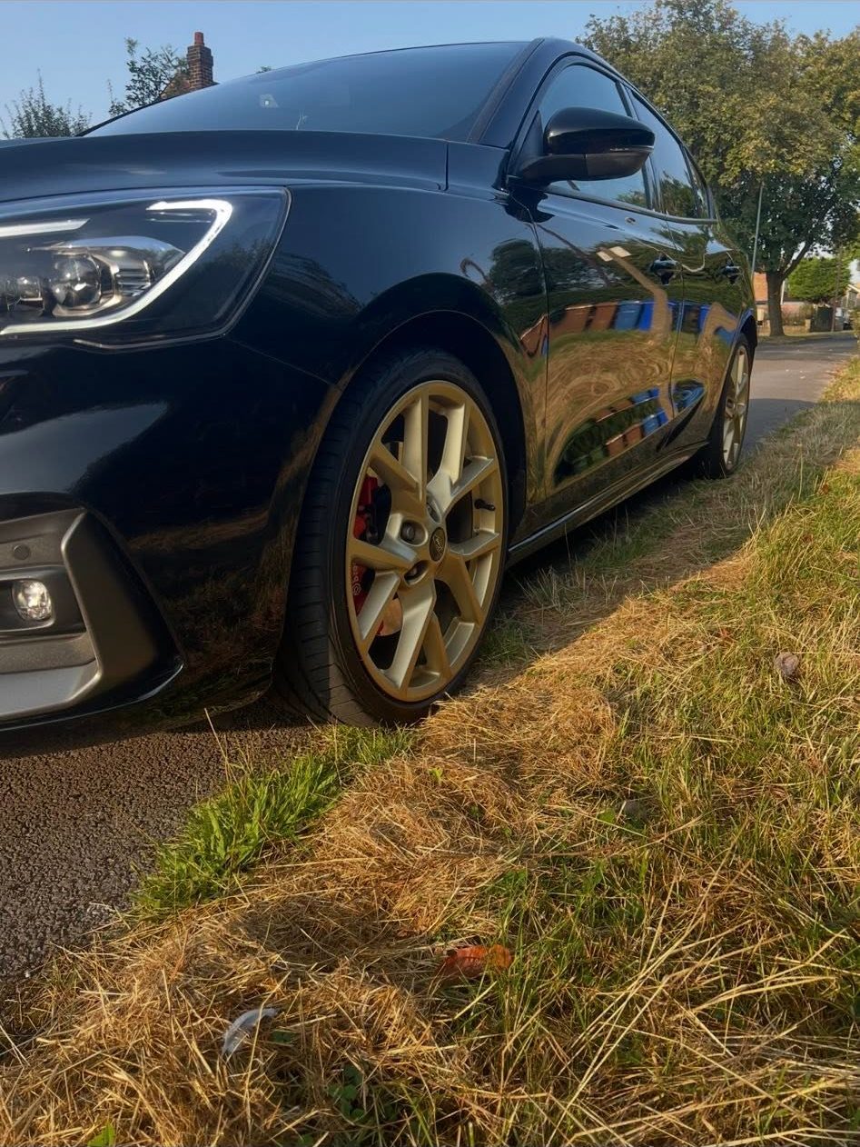 Black Ford Focus ST with custom gold alloy wheels