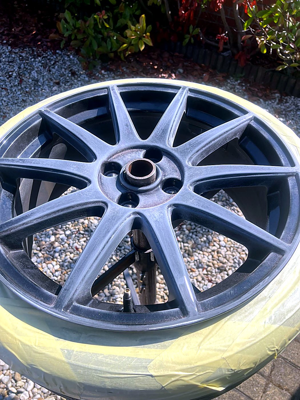 Ford Focus RS alloy wheel masked up and sanded ready for paint